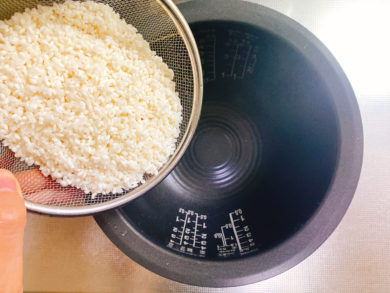 お米を炊飯器に入れている写真